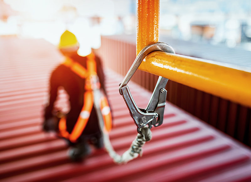 Construction worker wearing safety harness.